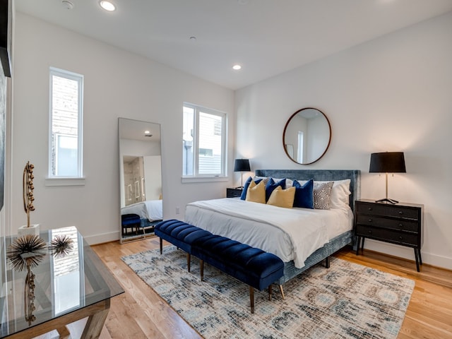 bedroom featuring multiple windows and wood-type flooring