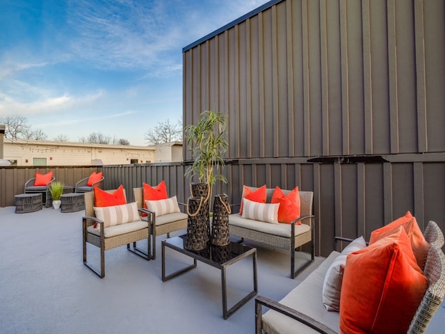 view of patio with an outdoor living space with a fire pit