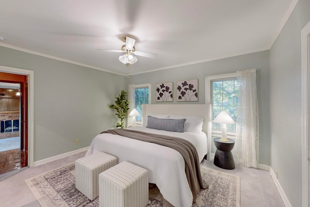 carpeted bedroom featuring ceiling fan and ornamental molding