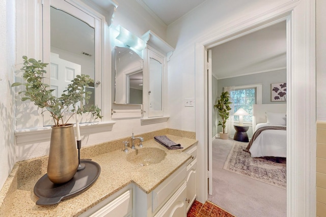 bathroom with vanity and crown molding