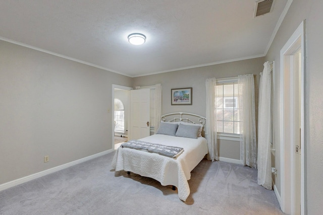 carpeted bedroom with a textured ceiling and crown molding