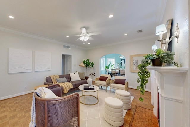 living room with light parquet floors, ceiling fan, and crown molding