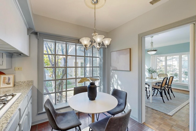 dining room featuring dark parquet floors and an inviting chandelier