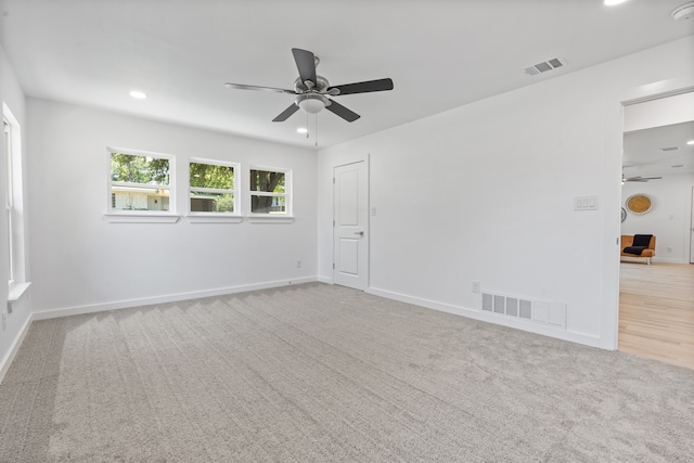 carpeted empty room featuring ceiling fan