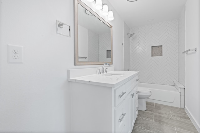 full bathroom with vanity, toilet, and tiled shower / bath