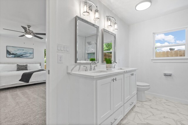 bathroom with ceiling fan, plenty of natural light, vanity, and toilet