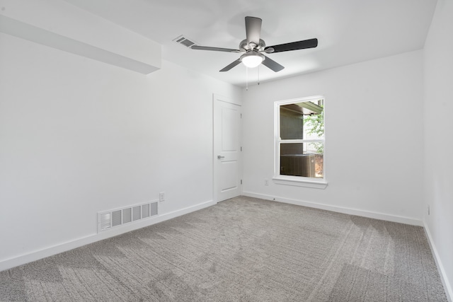 carpeted spare room with ceiling fan