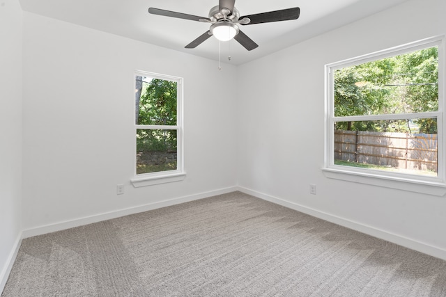 carpeted empty room featuring ceiling fan