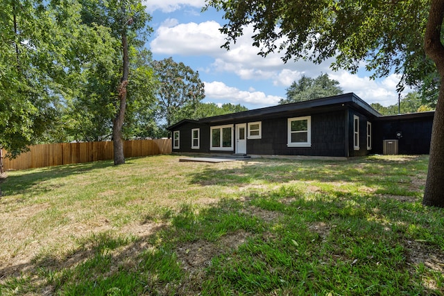 rear view of house with a yard