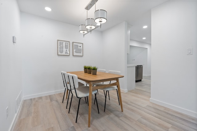 dining space with light wood-type flooring