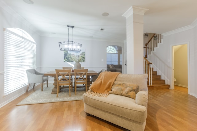 dining area with light hardwood / wood-style flooring, plenty of natural light, and crown molding