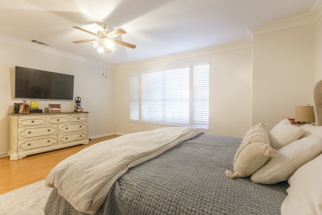 bedroom featuring ceiling fan, light hardwood / wood-style floors, and ornamental molding