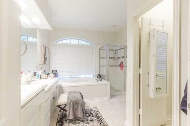 bathroom featuring tile patterned floors, vanity, and shower with separate bathtub