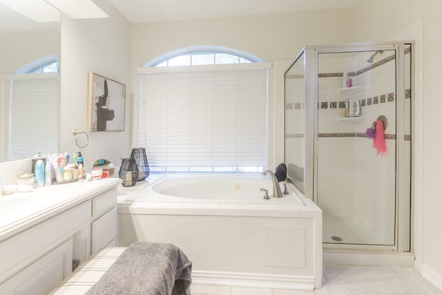 bathroom featuring vanity and shower with separate bathtub