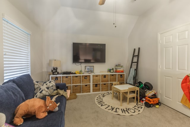 carpeted living room featuring ceiling fan and lofted ceiling