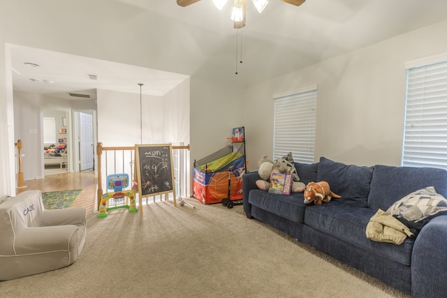 carpeted living room with ceiling fan