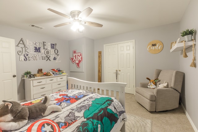 carpeted bedroom featuring ceiling fan and a closet