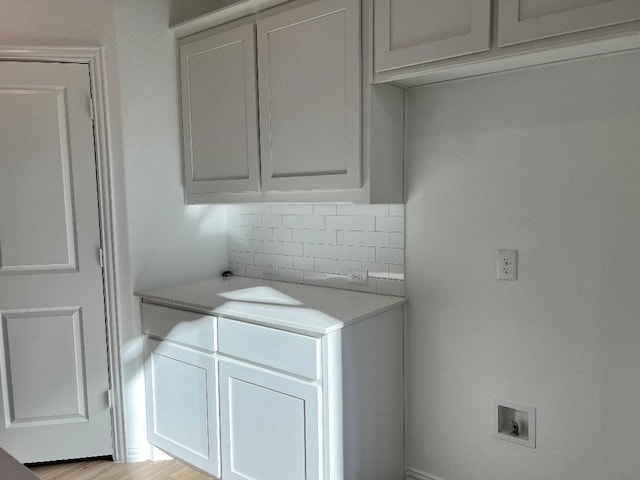 washroom featuring washer hookup and light hardwood / wood-style floors