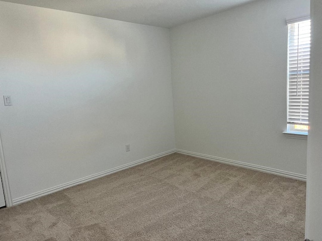 spare room featuring a healthy amount of sunlight and light carpet