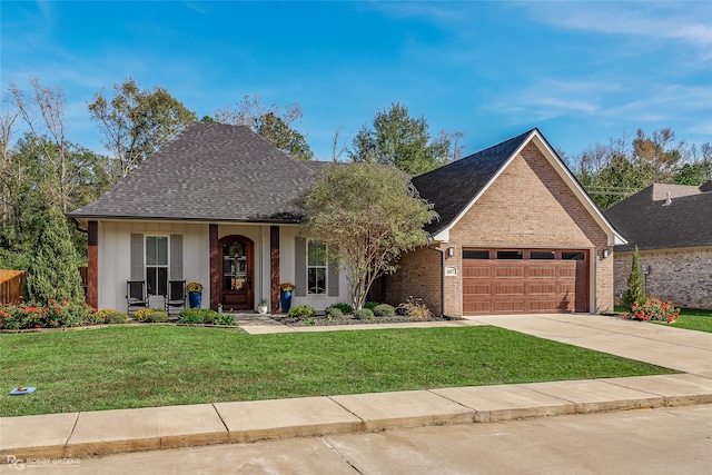 view of front of house featuring a garage and a front lawn