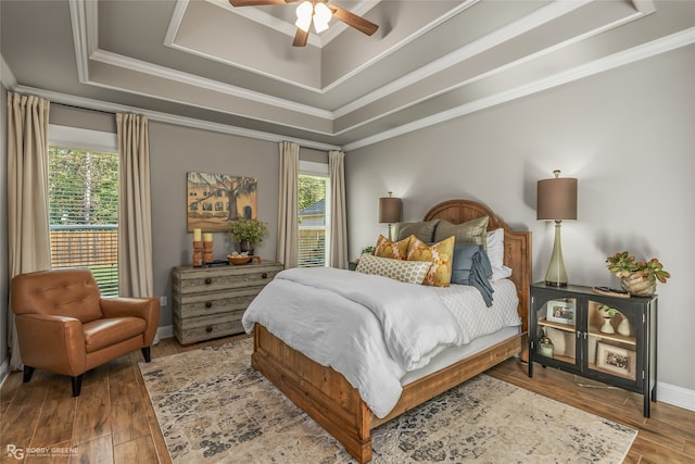 bedroom featuring hardwood / wood-style flooring, multiple windows, and ceiling fan