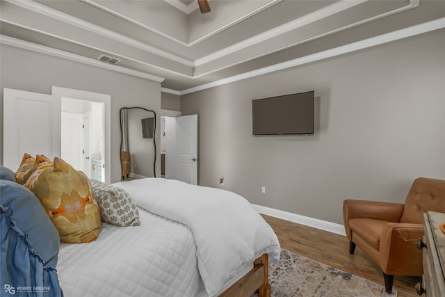 bedroom featuring hardwood / wood-style floors, ceiling fan, and ornamental molding