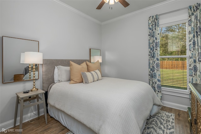 bedroom featuring ceiling fan, dark hardwood / wood-style flooring, and crown molding