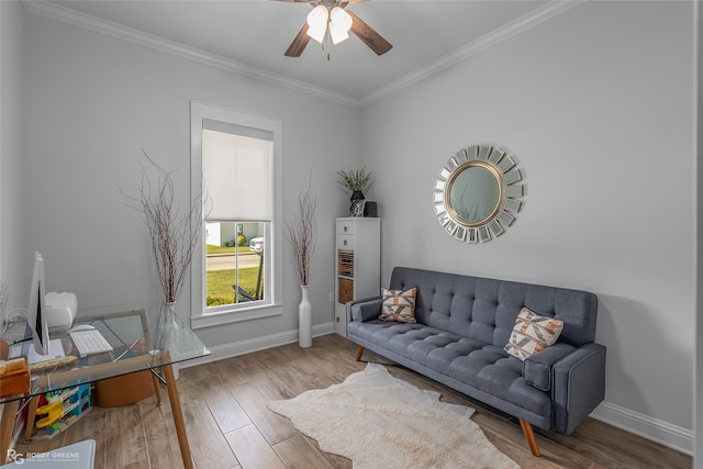 sitting room with hardwood / wood-style flooring, ceiling fan, and crown molding