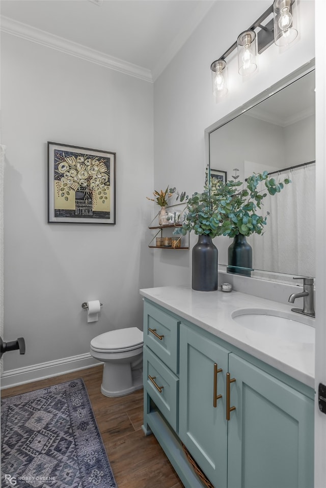 bathroom featuring curtained shower, crown molding, toilet, vanity, and hardwood / wood-style flooring