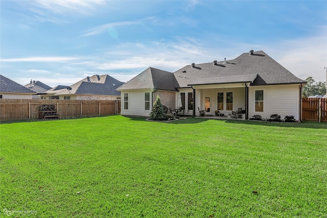 back of property featuring a yard and a patio area