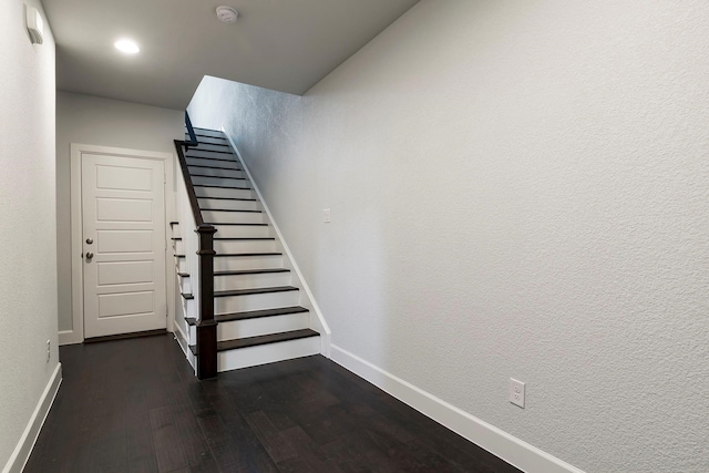 stairs featuring hardwood / wood-style flooring