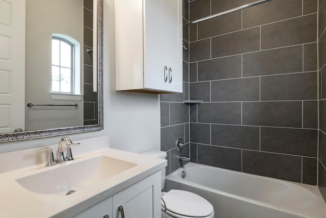 full bathroom with vanity, tiled shower / bath combo, and toilet