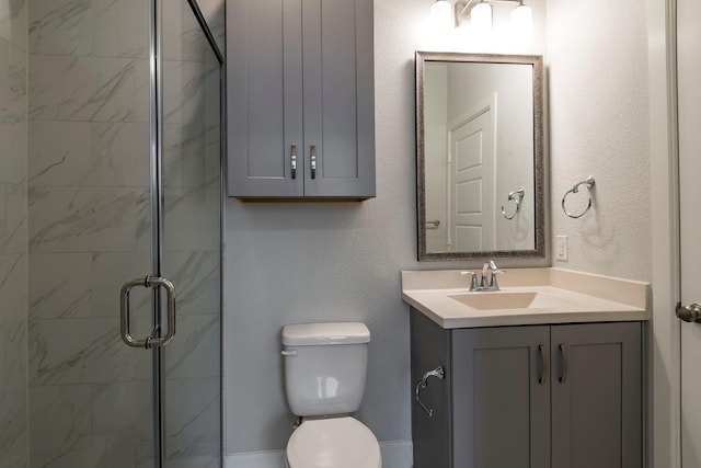 bathroom with vanity, toilet, and an enclosed shower