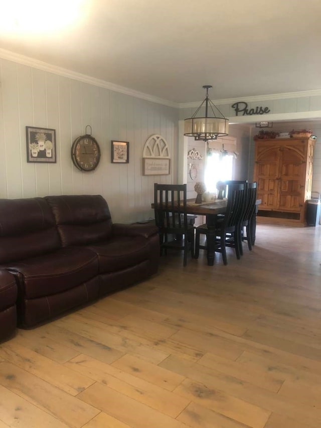 dining room with wood-type flooring, crown molding, and a chandelier