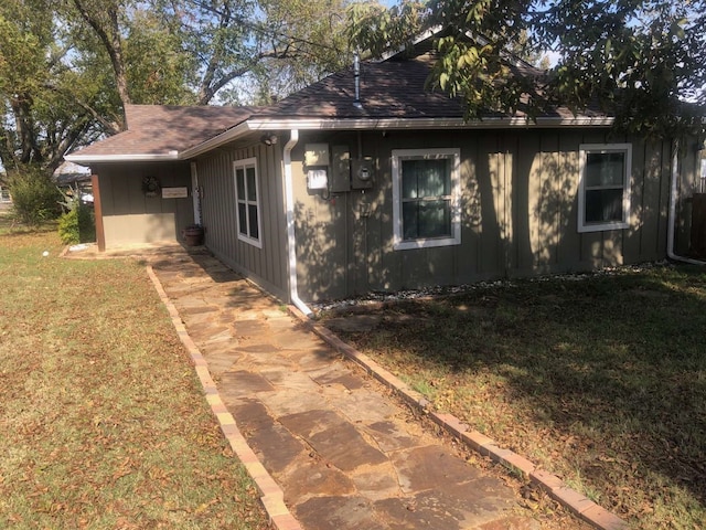 view of side of home with a lawn