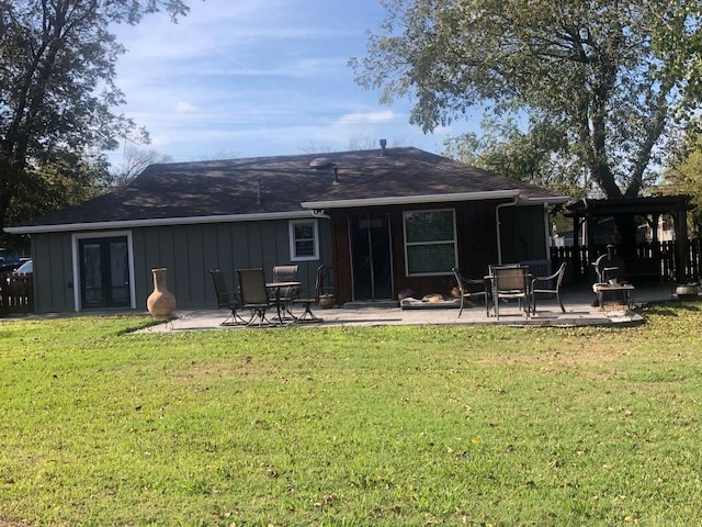 rear view of property with a yard and a patio