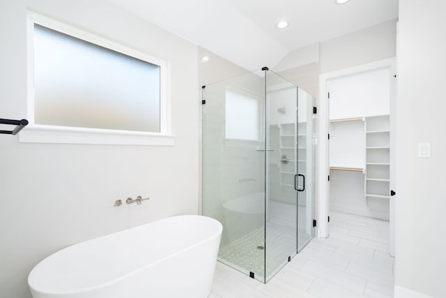 bathroom featuring plenty of natural light and plus walk in shower