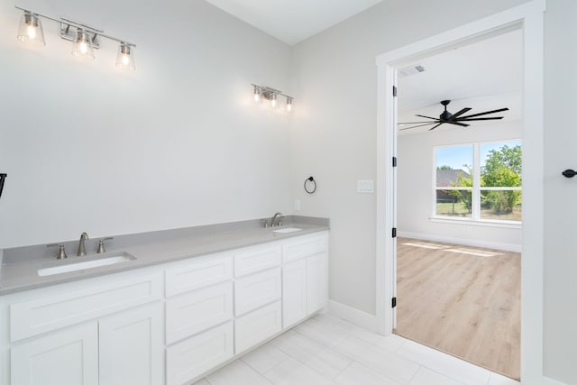 bathroom with hardwood / wood-style flooring, vanity, and ceiling fan