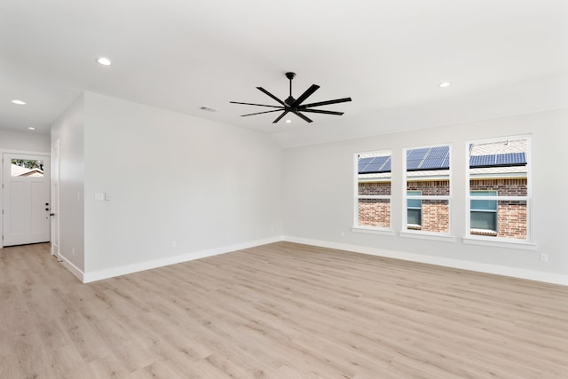 empty room with ceiling fan and light hardwood / wood-style floors