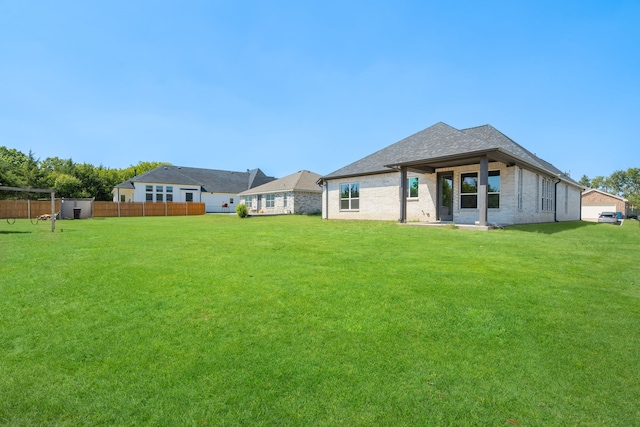 rear view of house with a yard