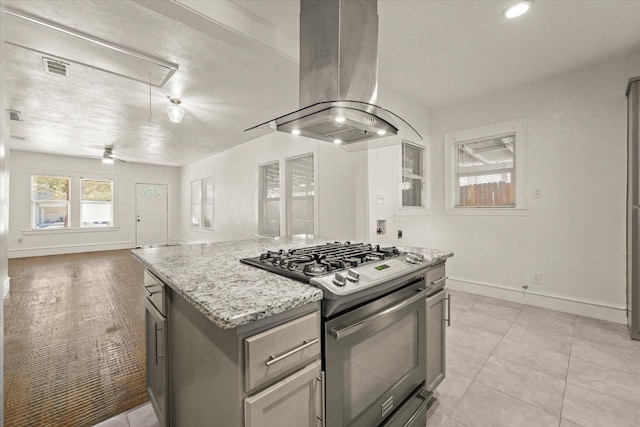 929 S Rosemont Ave, Dallas, TX 75208 - kitchen featuring gas range, island exhaust hood, baseboards, a ceiling fan, and open floor plan
