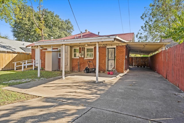 929 S Rosemont Ave, Dallas, TX 75208 - back of property featuring driveway, brick siding, and an attached carport