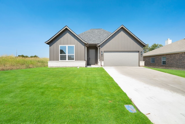 view of front of home with a front yard and a garage