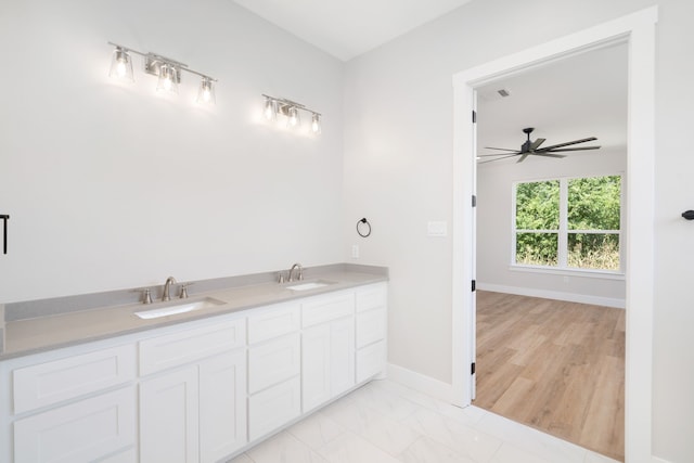 bathroom with ceiling fan, wood-type flooring, and vanity