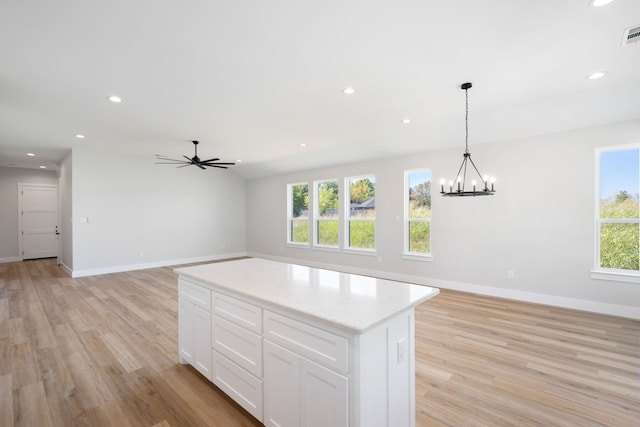 kitchen with white cabinetry, plenty of natural light, hanging light fixtures, and light wood-type flooring