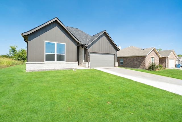 view of front of home with a garage and a front lawn