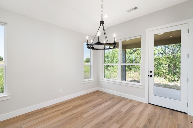 unfurnished dining area featuring a healthy amount of sunlight and light hardwood / wood-style floors