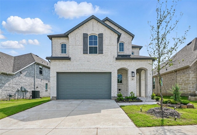4182 Carter Ct, Denison, TX 75020 - french provincial home with a garage, brick siding, central air condition unit, and concrete driveway
