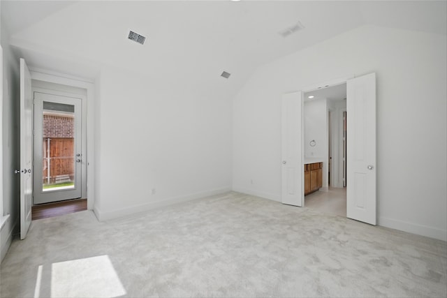 4182 Carter Ct, Denison, TX 75020 - empty room featuring lofted ceiling, light carpet, and baseboards