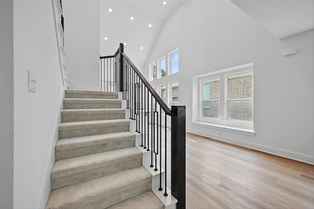 4182 Carter Ct, Denison, TX 75020 - stairs with recessed lighting, wood finished floors, high vaulted ceiling, and baseboards